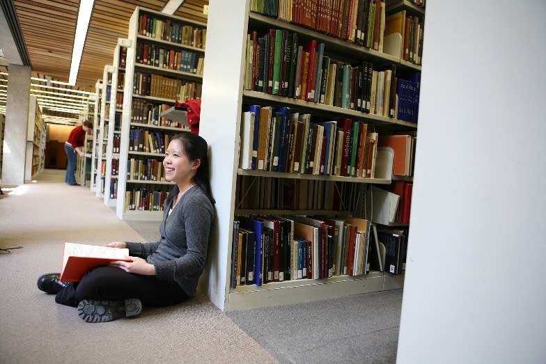 Kitty Cheung reads in the Bata Library stacks