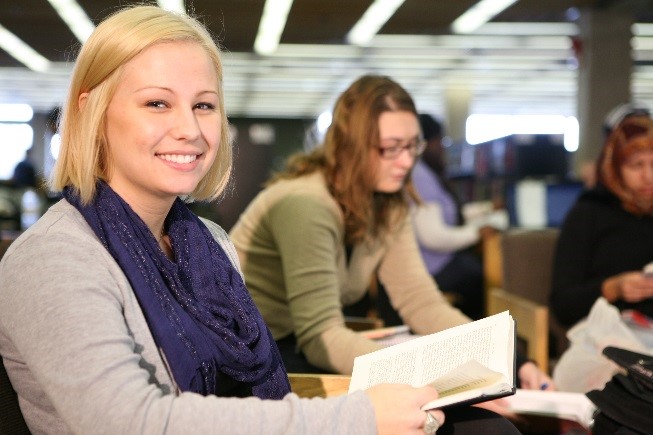 Krista Hewett (BA Hons., History) reads on the main floor of Bata Library