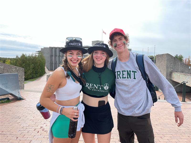 A picture of three alumni taken at the Bata podium