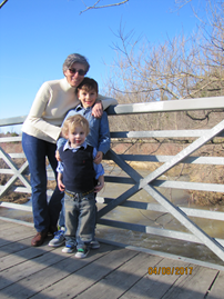 Connie Bonello standing on a bridge with two children