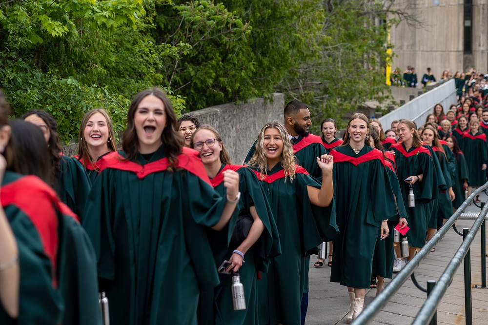 Group of Graduates crossing bridge