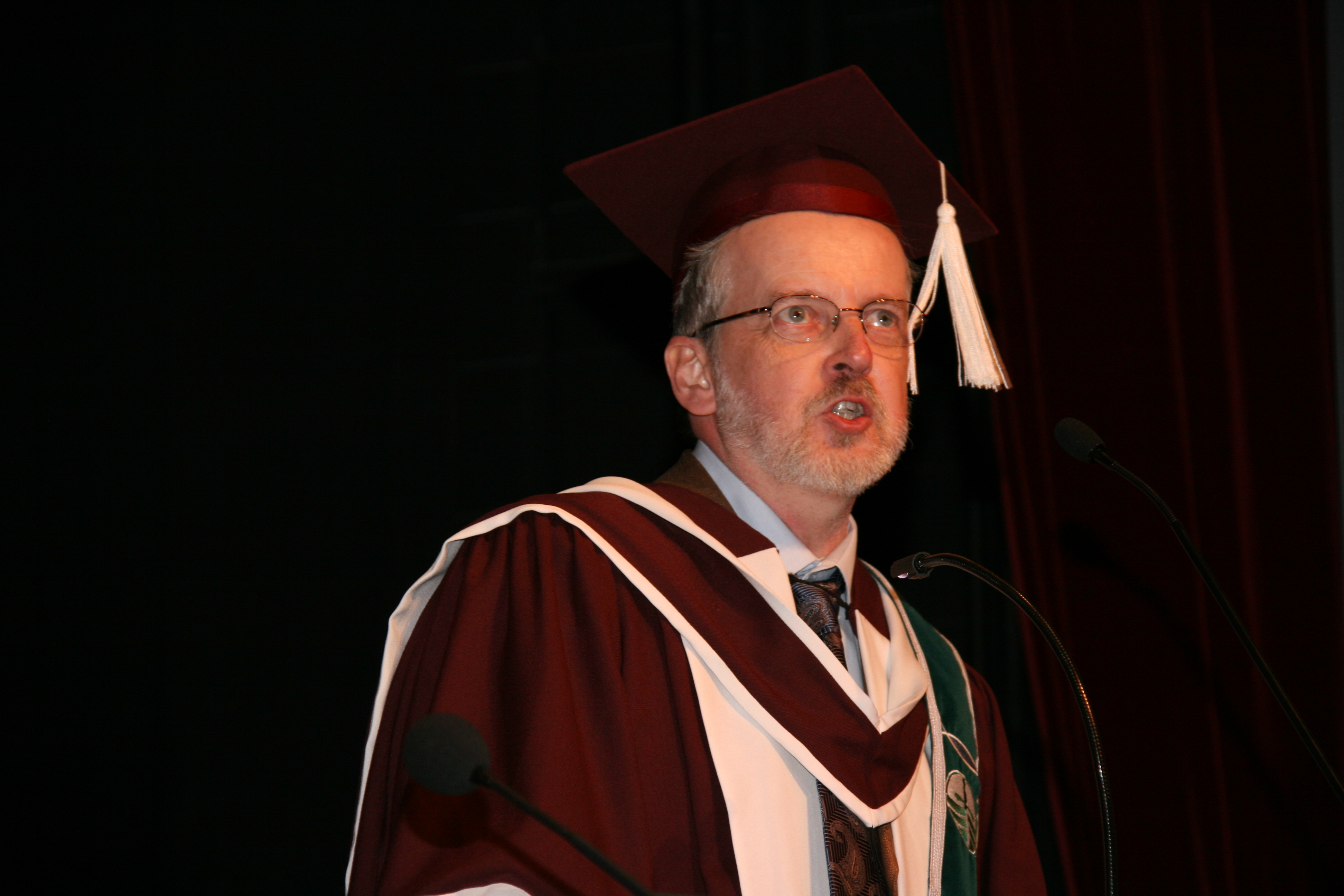 Headshot of David Poole speaking at ceremony.