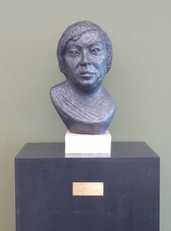 Bronze sculpture - bust of Margaret Laurence on marble base and wooden stand