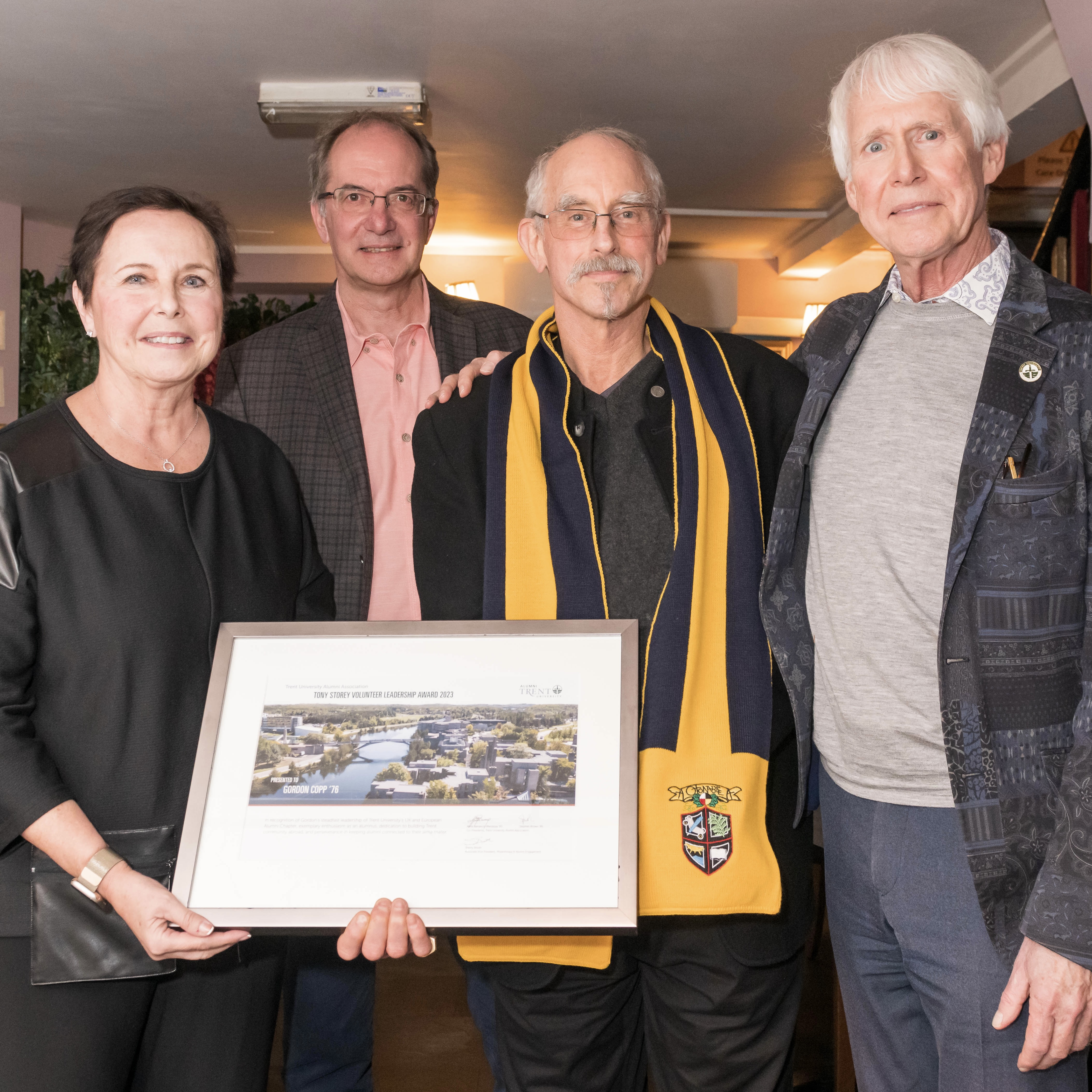 The UK chapter posing with Gordon Copp and his award