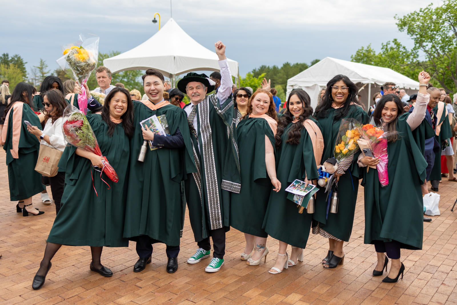 A group of graduating students standing on the bridge with President Leo Groarke