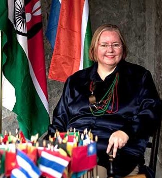 Lucie Edwards sitting with the flags of the world in front of her