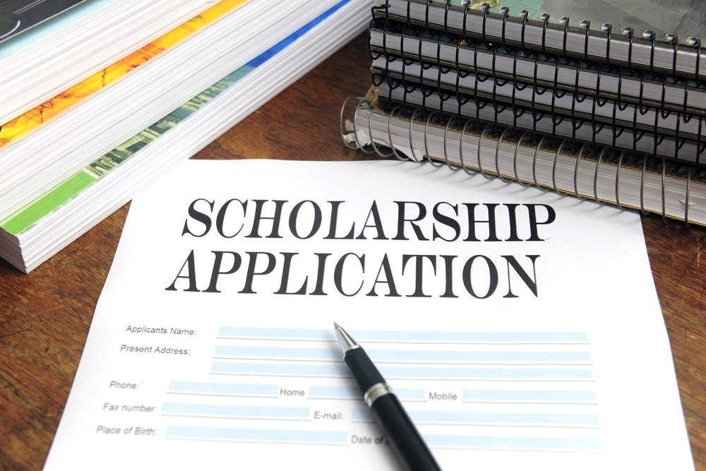 scholarship application on desk among books