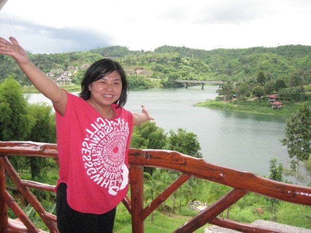 Vipa standing on a bridge in front of a body of water